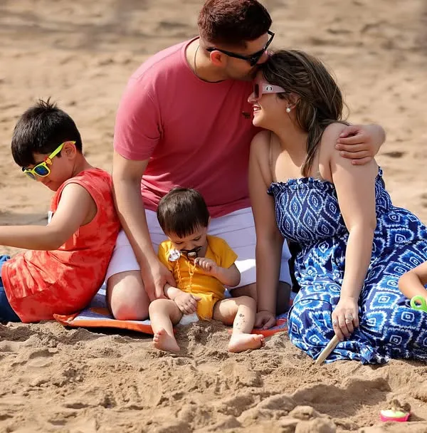 A quiet moment of connection for a family on a sunny day at the beach. We focus on capturing these natural interactions that you'll treasure for years.