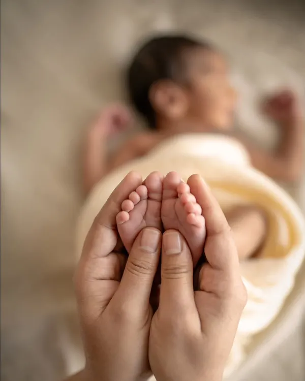 Those tiny feet make the biggest footprints in our hearts. This is the kind of fleeting, tender moment I live to capture, a simple reminder of how small they once were.