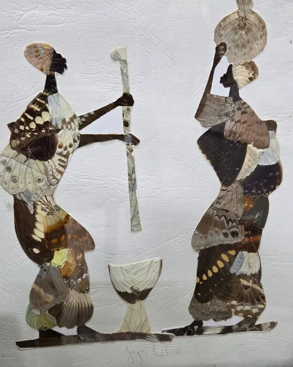 This unique artwork is crafted entirely from naturally sourced butterfly wings. The artist meticulously arranges the wings to create the silhouettes of two figures, blending natural beauty with cultural art in a truly imaginative way.