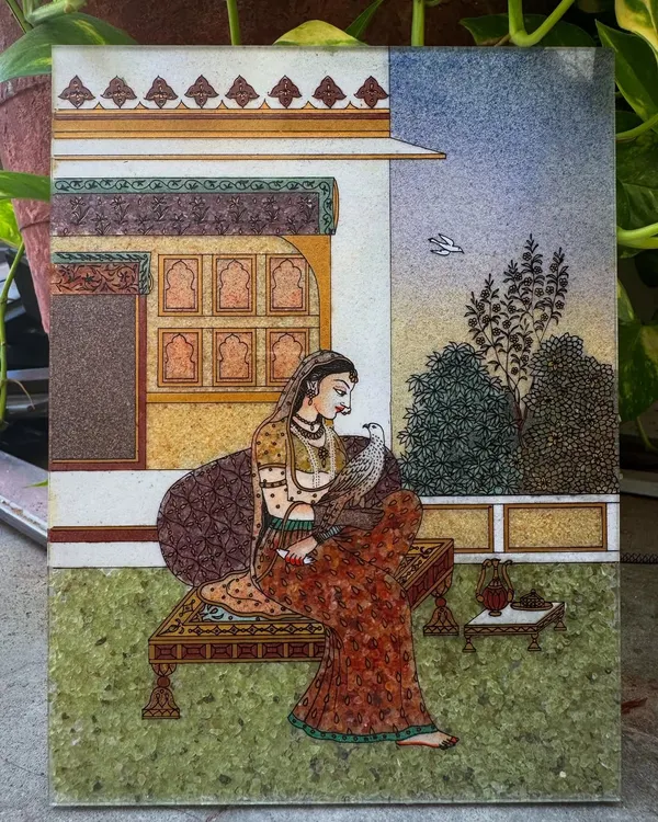 This painting of Bani Thani is a tribute to the timeless elegance of Rajasthani royalty. Inspired by the famous Kishangarh school of art, I use finely crushed gemstones to capture the grace and intricate details of her attire and the royal haveli setting. It is a piece of our heritage, designed to bring a sense of history and refinement to your space.