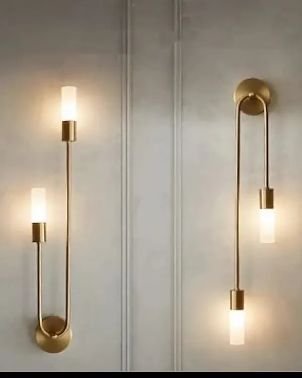 A pair of modern U-shaped wall sconces in a brass finish. These elegant fixtures provide both up and down lighting, adding a sophisticated touch to any wall.