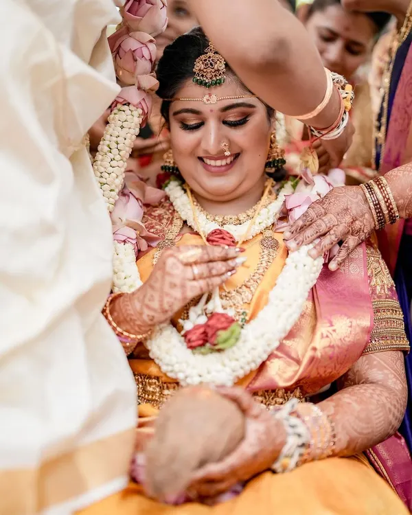 A beautiful candid moment of our bride Bhumi during her wedding ceremony. Her joyful smile captures the essence of a dream wedding coming to life, surrounded by the love of her family.