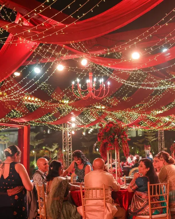 We believe a reception should feel like a galaxy of joy. For this night, we draped the sky in rich red fabric and a constellation of fairy lights, creating a warm, vibrant space where guests could share laughter and make memories under the stars.