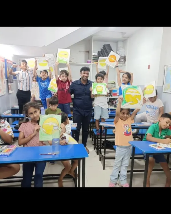 The joy of creation. Our students proudly hold up their finished paintings for the camera, their faces beaming with a sense of accomplishment after a productive art session.