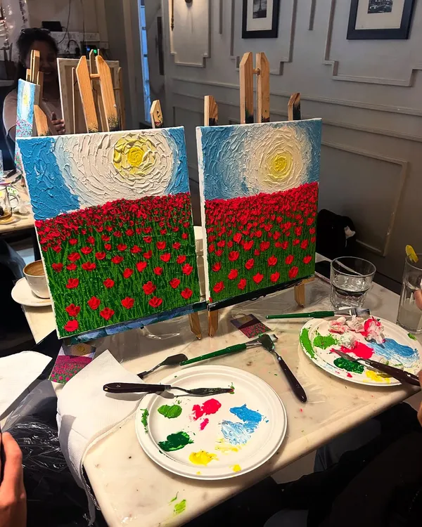 Two finished canvases side-by-side, showcasing a textured field of red poppies under a bright sun. You can see the thick acrylic paint applied with palette knives to create a 3D effect.