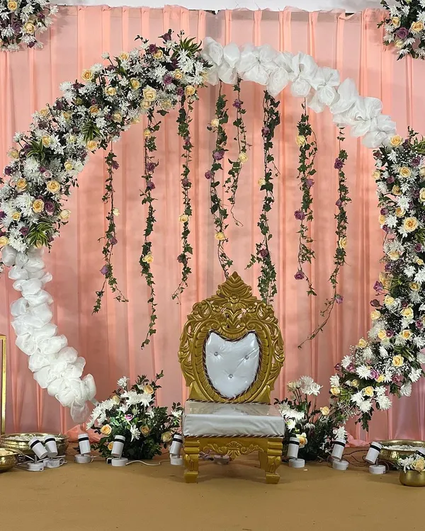This beautiful floral ring backdrop, with its mix of fresh flowers and hanging vines, creates a perfect stage for intimate celebrations. It's a versatile design that I've customized for two different clients, each time creating a unique and memorable setting.