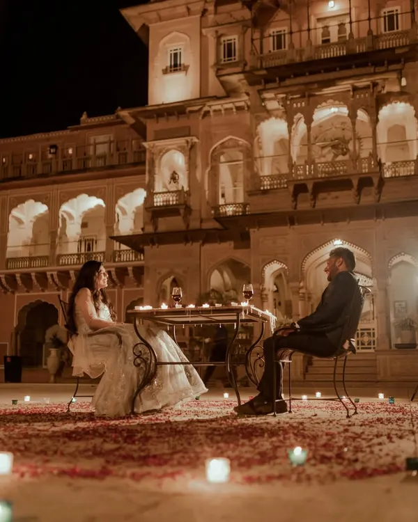 A fairytale evening brought to life. We set up this romantic, candlelit dinner against the stunning architecture of a Rajasthani palace, creating a private world just for the two of them. This is the kind of magical, cinematic pre-wedding experience we love to create.