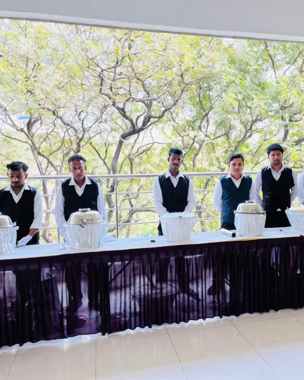 My team of servers standing by the buffet line at Janki Bai Madhvi Hall in Airoli. They are ready and waiting to assist guests during the wedding event.