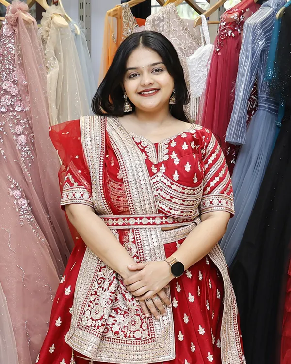 A happy customer trying on a beautiful red lehenga in my store. Her smile says it all.