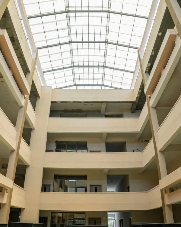 The central atrium at Konark Academy is the heart of the building, designed to foster connection. A massive skylight floods the multi-story space with natural light, creating a bright and airy core that all classrooms open onto.