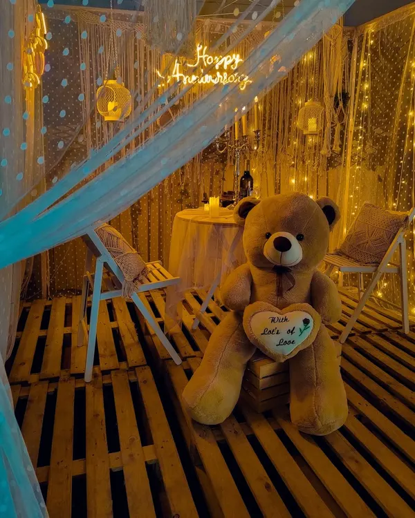 I design intimate and romantic settings like this "Macrame Bliss" anniversary surprise. The warm glow of fairy lights, neon signs, and cozy boho details create a perfect private celebration for two, whether it's on a rooftop or in your backyard.
