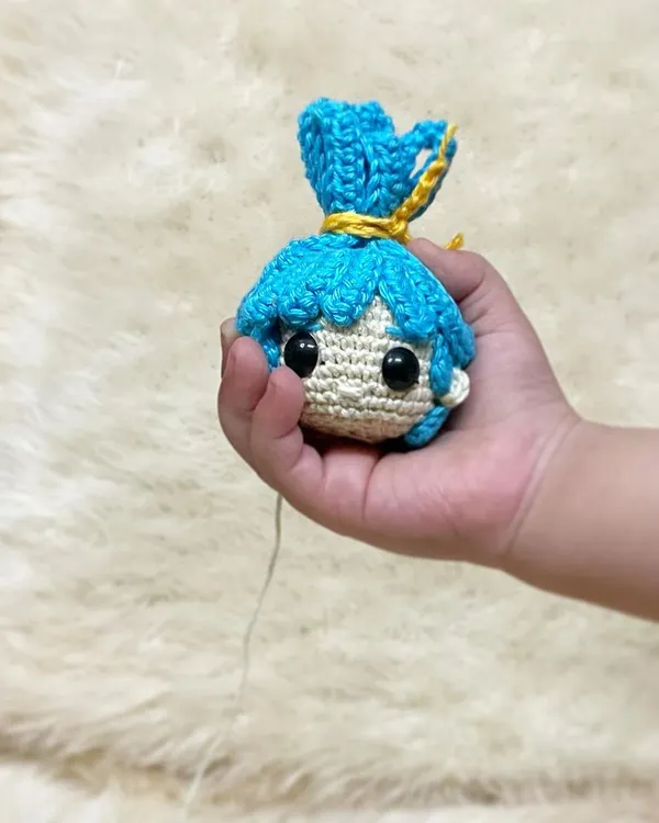 This is the head of a custom doll being held by my sweet nephew. It shows the beginning stages of a doll coming to life, even before the body is attached.