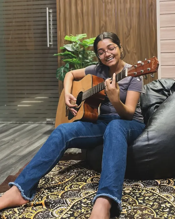 We designed our studio to be a place where you can feel comfortable and let your creativity flow. This is more than just a rental space; it's a home for musicians to relax, write, and play, like this cozy acoustic guitar session in our HSR Layout studio.