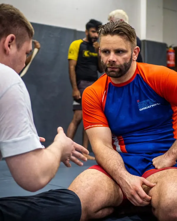 Learning from a master. BJJ black belt Mike Cave breaking down the details of a leg lock during his seminar at our academy. We provide access to elite-level instruction.