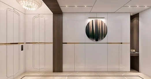 A grand entrance foyer sets the tone for the entire home. Here, we used sleek white paneling, warm wood accents, and a striking circular art piece to create a first impression that is both modern and welcoming.