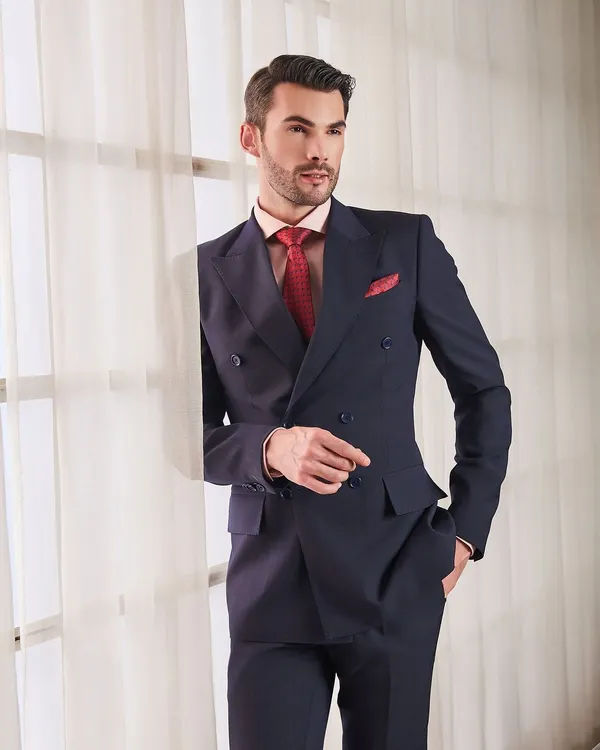 A classic navy double-breasted suit is the definition of power dressing. Tailored to perfection, this suit offers a commanding presence while the premium fabric ensures it remains comfortable throughout the day.