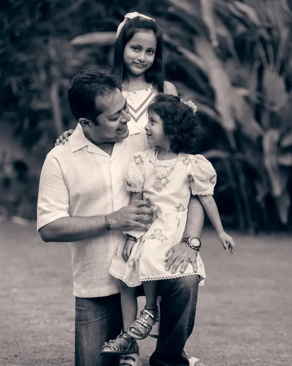 A father's loving gaze at his daughter. This black and white family portrait emphasizes the emotional connection and timeless nature of their bond.