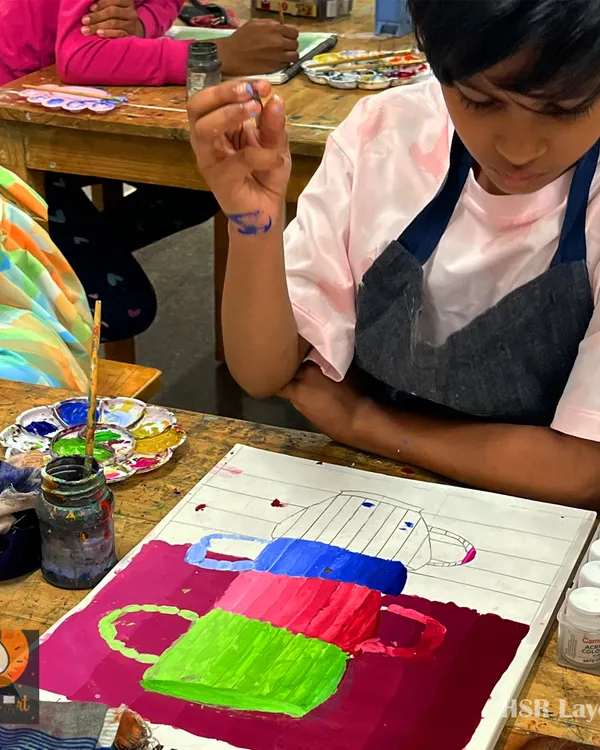 A young artist learns about color blocking and composition. This exercise with stacked cups helps build confidence with the brush and an understanding of basic shapes.