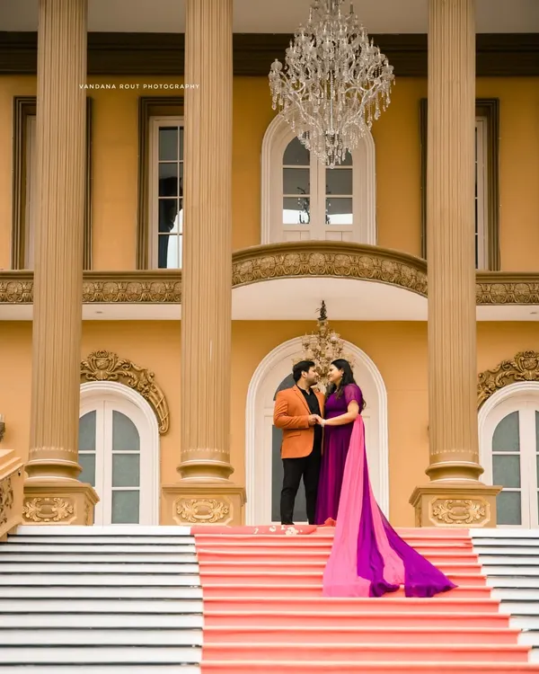 A regal setting for a royal love story. This shot at a palatial location in Bangalore uses grand architecture and a stunning chandelier to frame the couple's intimate moment.