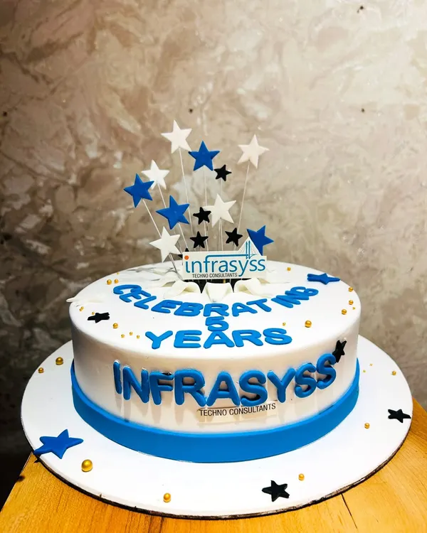 A corporate cake celebrating 8 years of Infrasyss Techno Consultants, featuring the company logo and a star-studded design.