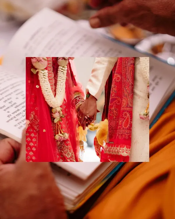 A close-up of the couple holding hands during the ceremony, framed by a holy book. This shot symbolizes their union and the sanctity of the moment.