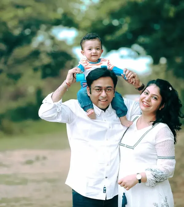 This is what it's all about. A happy family portrait taken outdoors in Bangalore, with everyone relaxed and smiling. I love capturing these natural moments of connection, like this little one enjoying a ride on dad's shoulders.