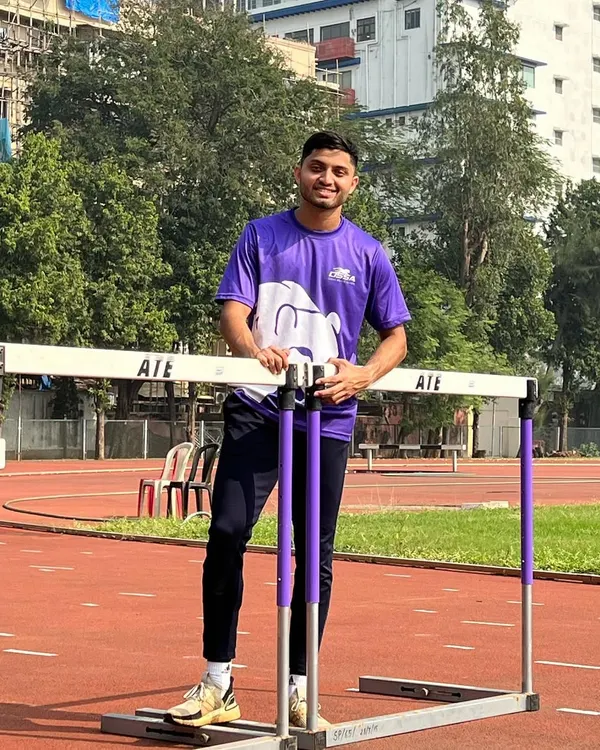Our record-holding 110m hurdler, Alden Noronha, posing with the equipment that is central to his craft.