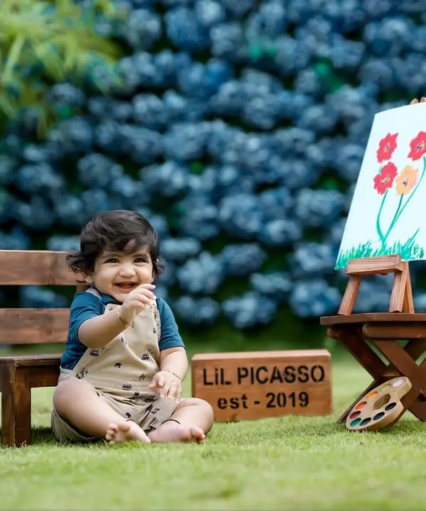 Our 'Lil Picasso' theme is a favorite! This little artist is all smiles with his easel and paints in our beautiful garden setting.