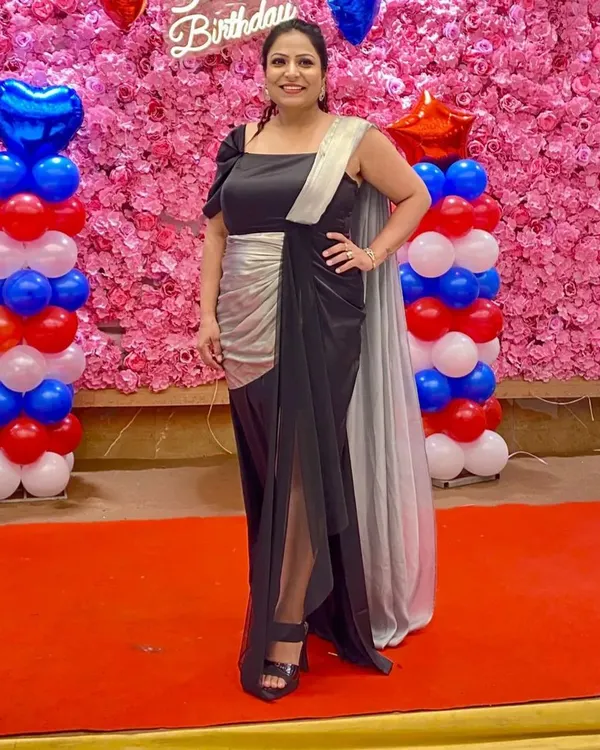 My client shines in this classy, custom-made black and silver gown for her birthday. Seeing her look so elegant and happy is why I love what I do.