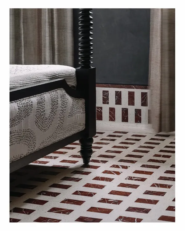 This black four-poster bed was custom-designed for the 'Aria' master bedroom. Its strong, sculptural form stands in beautiful contrast to the patterned marble and IPS flooring, creating a space that feels both peaceful and powerful.