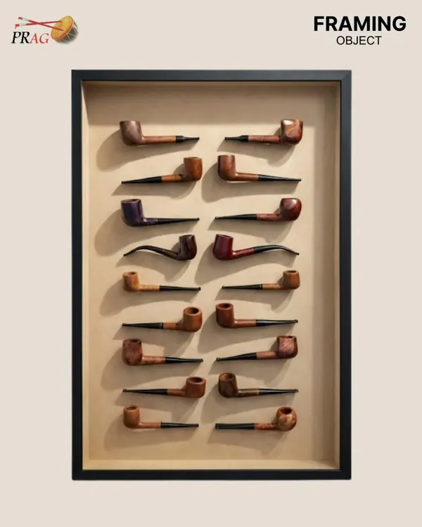 The finished masterpiece. This collection of 55 vintage pipes is mounted on an acid-free beige paper mount and housed in a black box frame with clear glass, turning a personal history into a sophisticated display.