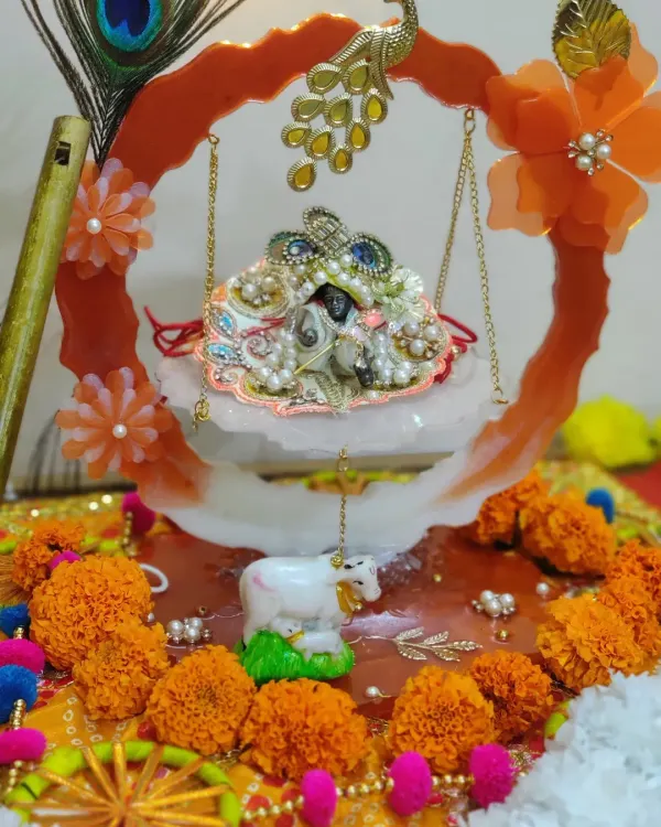 This is my beautiful handcrafted Laddu Gopal jhulla, all decorated and ready for Janmashtami celebrations. I love how the vibrant colors, peacock feather, and fresh marigolds come together to create a lovely home for Bal Gopal.