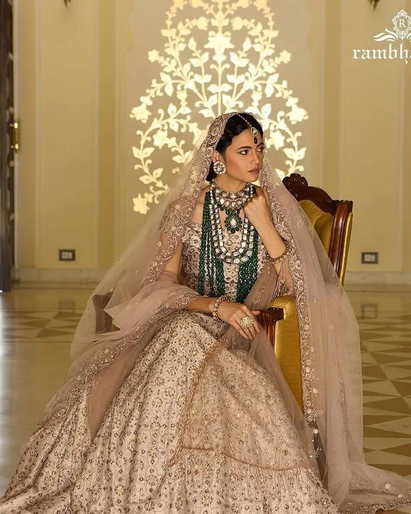 A regal bridal look styled for a Rambhajo's jewellery campaign. The focus was on layering magnificent emerald and polki necklaces over a delicately embroidered lehenga, creating an image of royal grandeur and timeless bridal beauty.