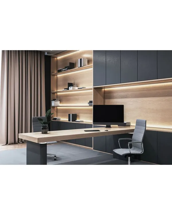 A sleek and modern home office with a minimalist aesthetic. The design features a long floating desk, integrated shelving with backlighting, and dark, handleless cabinetry for a clean and professional look.