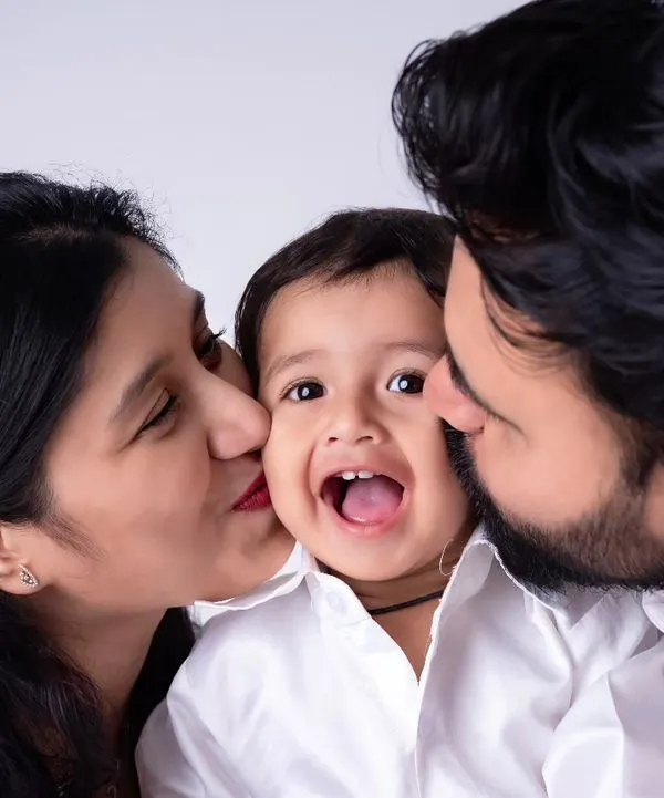 This is what it's all about: pure, unfiltered joy. I love capturing these candid family moments where everyone's relaxed and the laughter is real. This classic studio portrait shows how simple, happy interactions make for the most cherished memories.
