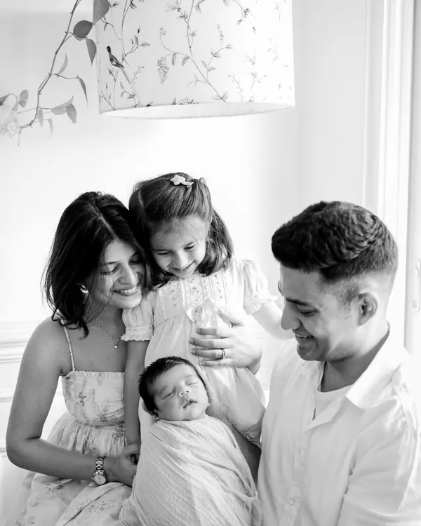This black and white family portrait is everything I love about my job. The gentle way big sister looks at her new baby brother, the proud smiles of the parents, it's a moment of pure, unadulterated love captured forever. These are the memories that become timeless treasures.