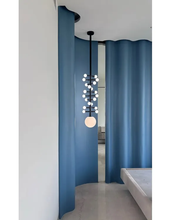 The custom DNA-patterned light fixture, seen here in its final form. This piece is a perfect example of how we use lighting to create a statement and add a sculptural element to a room.