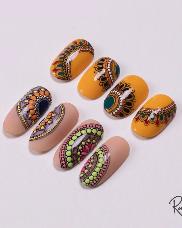 A collection of my hand-painted mandala nail art. The combination of earthy tones and bright colors makes these designs perfect for any festive occasion.