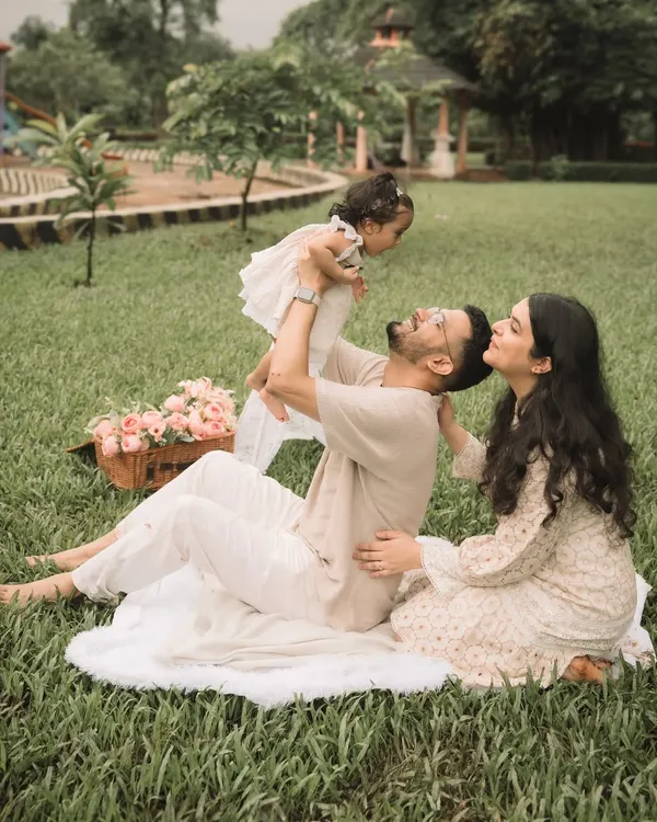 A father joyfully lifting his daughter into the air during an outdoor session. These playful moments create the most authentic photos.
