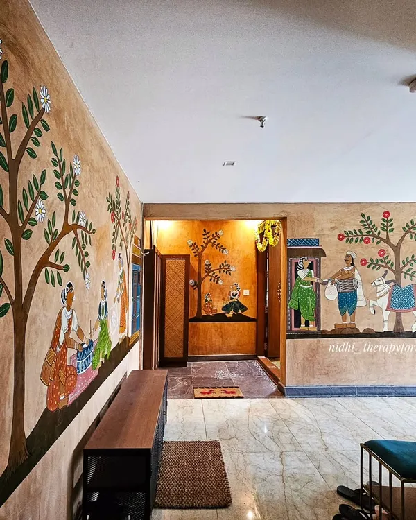 This wide view shows how the different Cheriyal scenes connect to create a flowing narrative along the corridor of this Andhra-style apartment, transforming it into a village path.