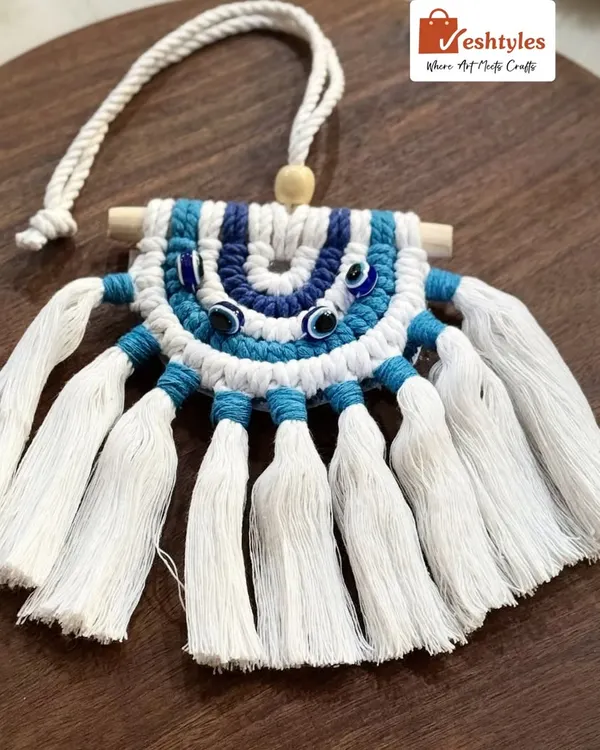This is my classic evil eye car charm, designed to protect you on your journeys. It features the traditional blue and white colors, with intricate knotting and a wooden dowel. It's a perfect gift for yourself or a loved one.