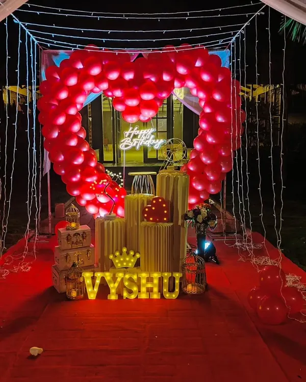 Our signature romantic cabana is perfect for an unforgettable surprise. It features a canopy of fairy lights, a red carpet walkway, and a stunning heart-shaped arch made of red balloons.