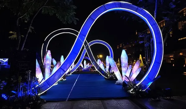 We designed this celestial sangeet entrance to feel like a journey into another galaxy. The glowing infinity loops and crystal-like structures, lit with cosmic projections, created a truly magical walkway for the couple and their guests at the Della Adventure Resorts.