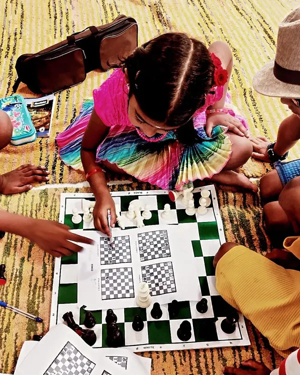 This is what our classes are all about: collaboration, fun, and cracking the code of chess together. Here, a group of our young students are deeply engaged in solving chess puzzles on a worksheet, learning key patterns and strategies in a vibrant, supportive group setting.