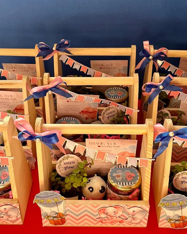 These budget-friendly baby shower hampers are both cute and thoughtful. Each pinewood basket contains a resin planter with a jade plant and a jar of our handmade chocolates.