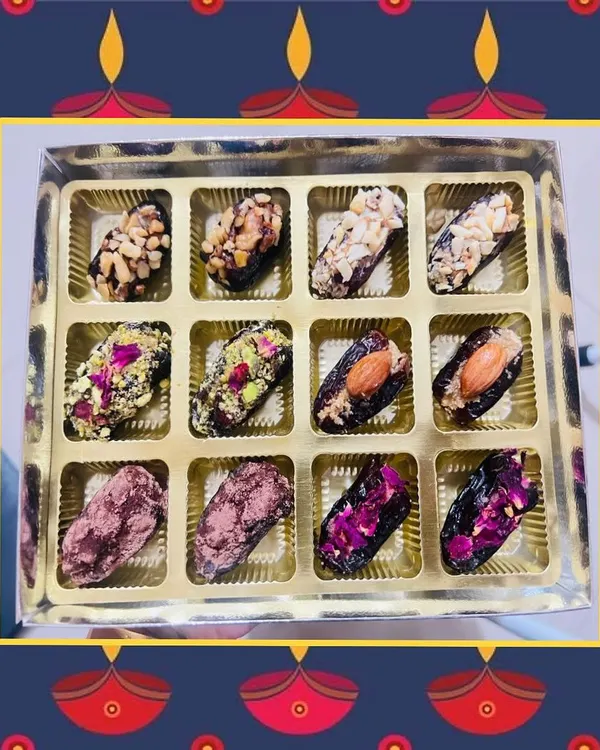 A box of my Diwali Special Vegan Stuffed Dates. Each one offers a unique flavor combination, from peanut and almond crunch to pistachio and rose petal toppings.