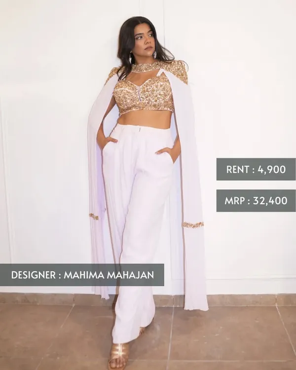 This modern and chic ensemble by Mahima Mahajan features an embroidered gold crop top with an attached cape and sleek white trousers. Originally ₹32,400, you can own it for just ₹4,900.