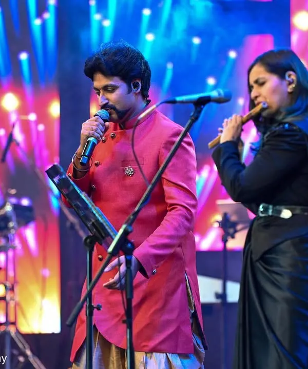 Performing with a fellow vocalist at the Bengaluru Ganesh Utsava. I love the energy of a big stage and sharing my flute and vocal music with a live audience.