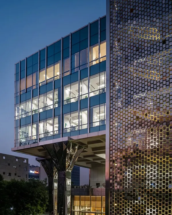 This dusk view of the Jindal Stainless Steel Office in Gurugram captures our expertise in large-scale commercial transformations, featuring an innovative 'shimmer screen' that redefines the building's façade.