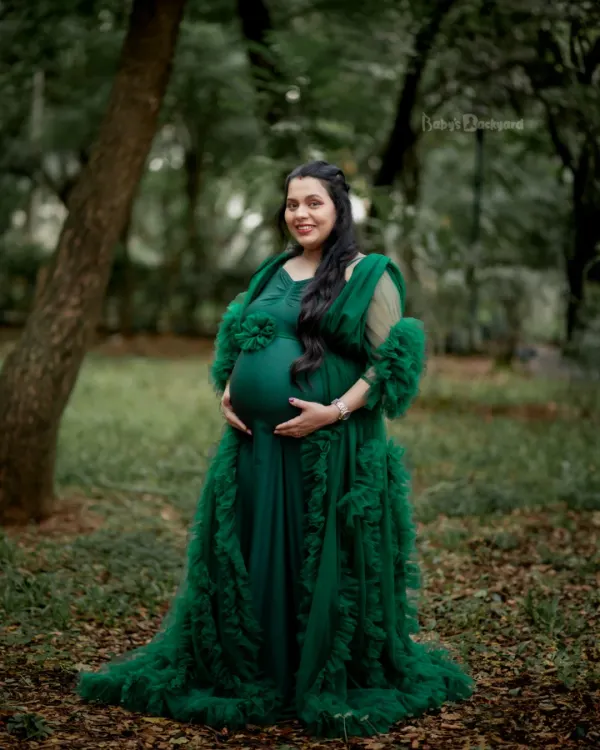 This is the magic of motherhood, wrapped in a flowing gown and surrounded by nature's gentle embrace. We love capturing this pure, radiant glow for expecting mothers during our outdoor pregnancy photoshoots.